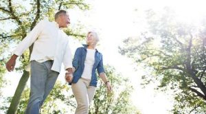 Shot of a happy senior couple enjoying a walk in the park together