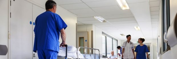 Doctors Hospital Corridor Nurse Pushing Gurney Stretcher Bed